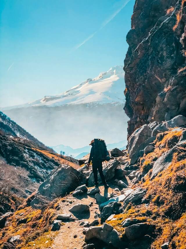 Hiker on a rocky mountain trail near Hampta in Himachal Pradesh